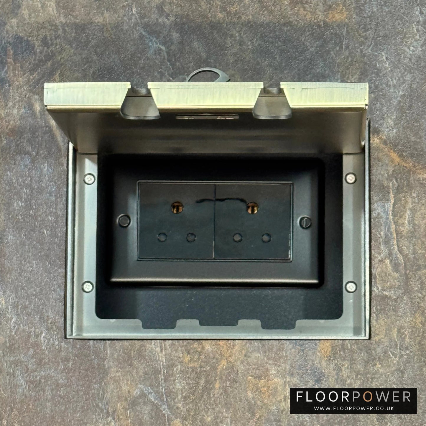 Antique Brass Double Recessed Flush Floor Socket with 5A Round Pin Sockets for Lighting in a stone floor.