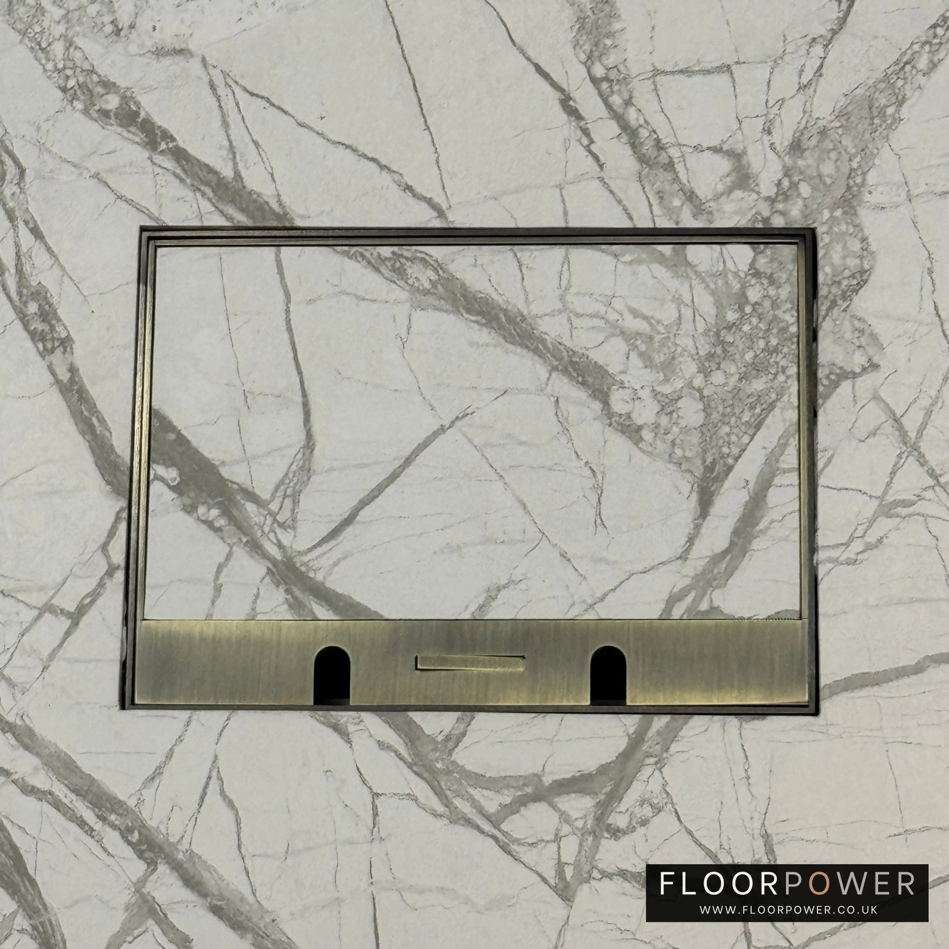 Antique Brass Double Recessed Flush Floor Sockets in a Marble Floor with the marble also inset into the lid.