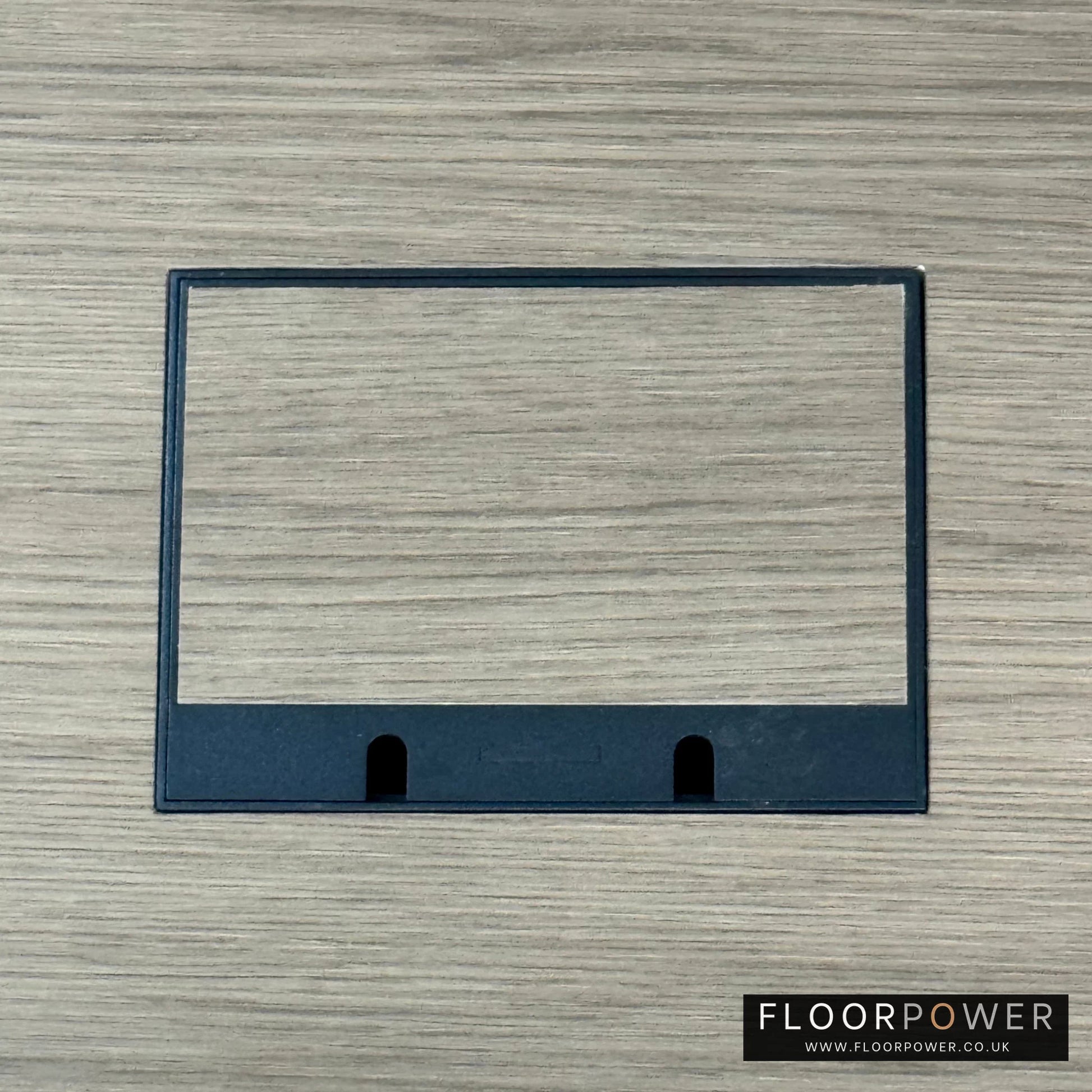 Matt Black Double Recessed Flush Floor Sockets in a Light Wood Floor with the wood flooring also inset into the lid.