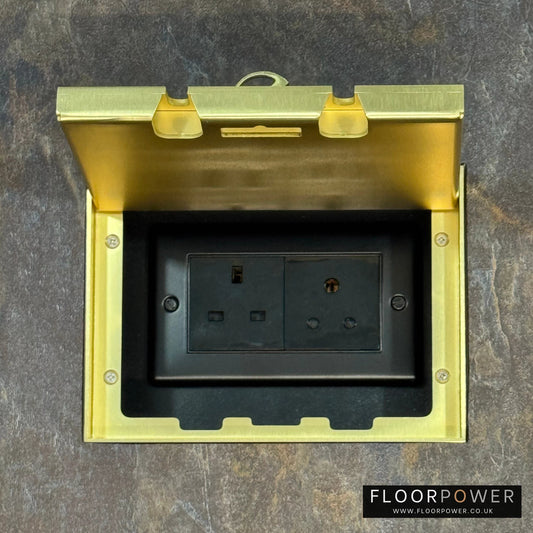 Satin Brass Double Recessed Flush Floor Lighting Combination Socket (13A & 5A Round Pin Plug Sockets) in a stone floor.