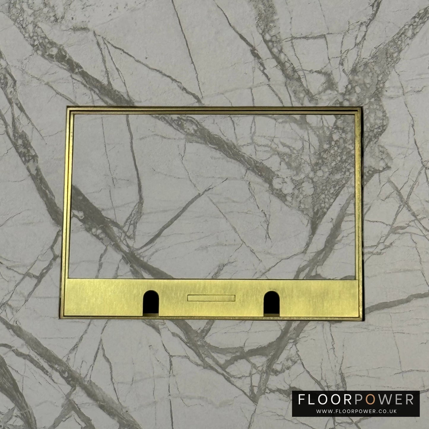 Satin Brass Double Recessed Flush Floor Sockets in a Marble Floor with the marble also inset into the lid.