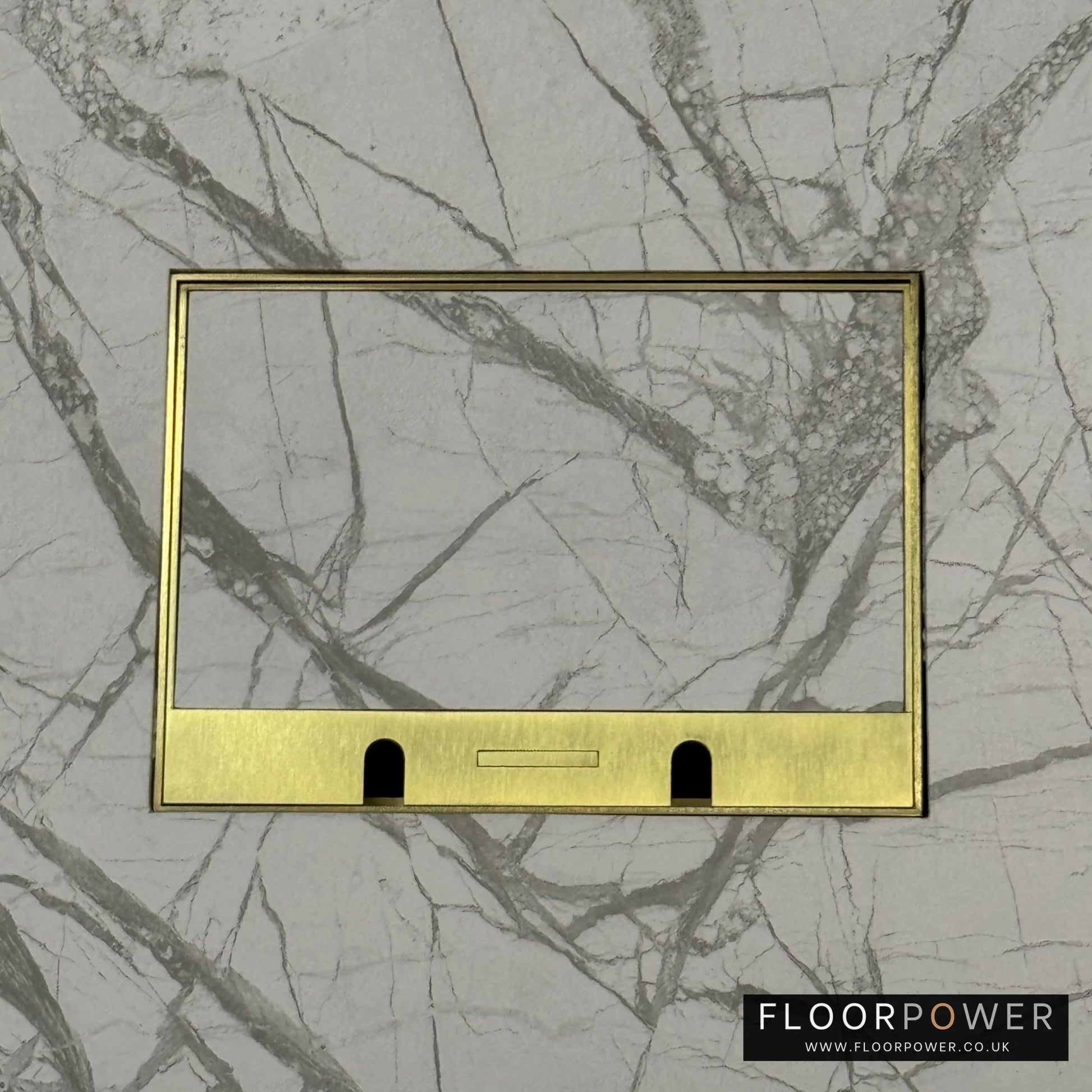 Satin Brass Double Recessed Flush Floor Sockets in a Marble Floor with the marble also inset into the lid.