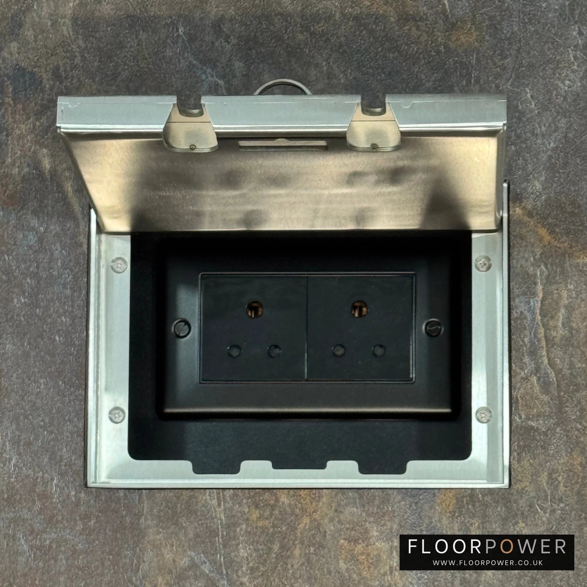 Satin Stainless Double Recessed Flush Floor Socket with 5A Round Pin Sockets for Lighting in a stone floor.