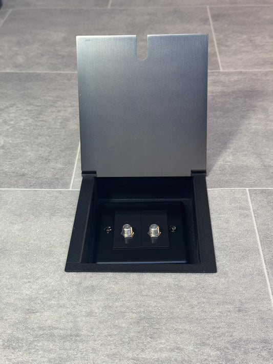 A single old bronze recessed floor socket with a 2 gang satellite socket.
