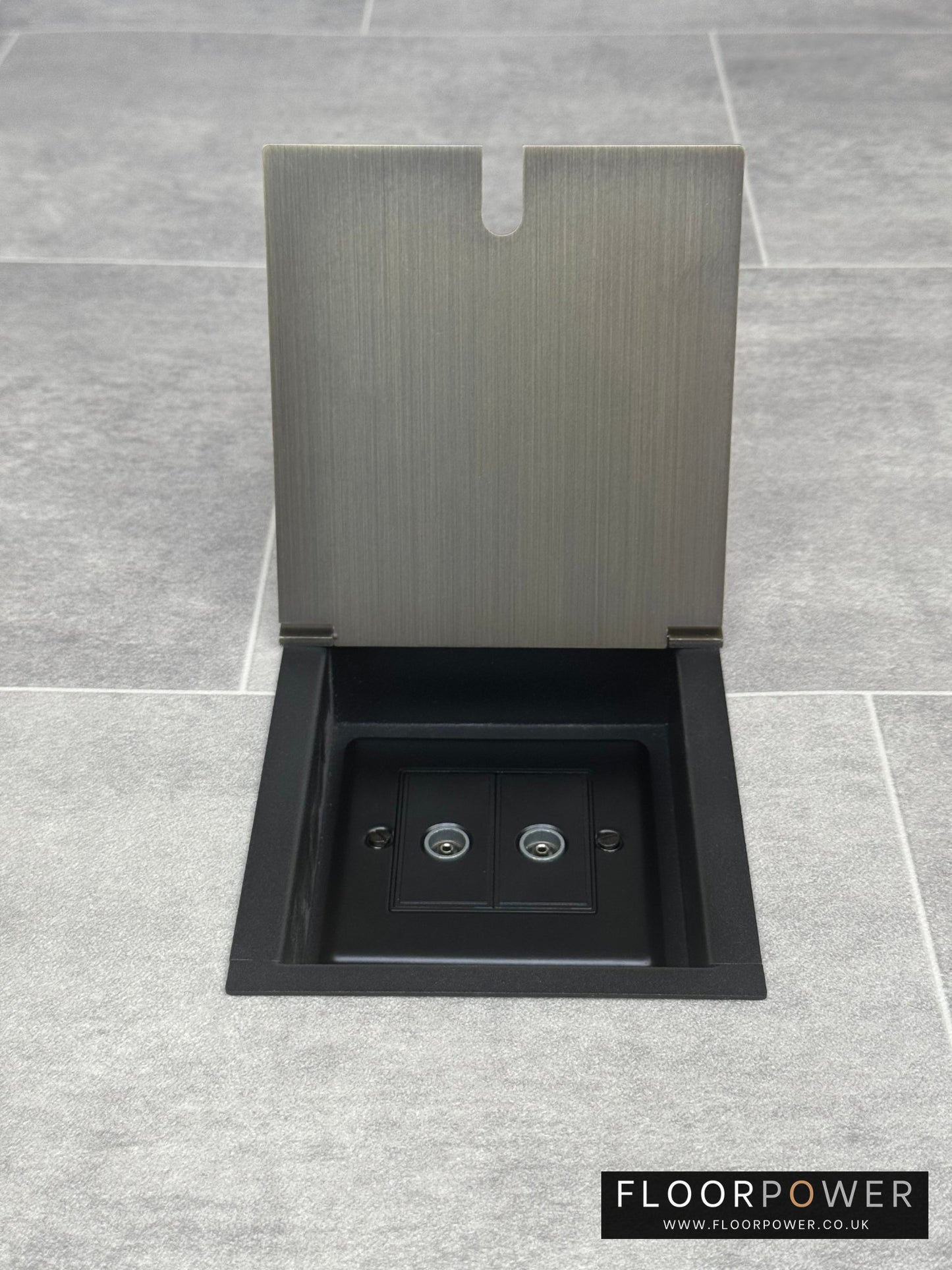 Antique brass recessed floor socket with an open cover revealing the 2 gang TV socket.