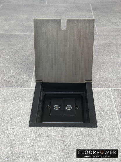 Antique brass recessed floor socket with an open cover revealing the 2 gang TV socket.