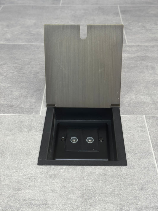 Antique brass recessed floor socket with an open cover revealing the 2 gang TV socket.