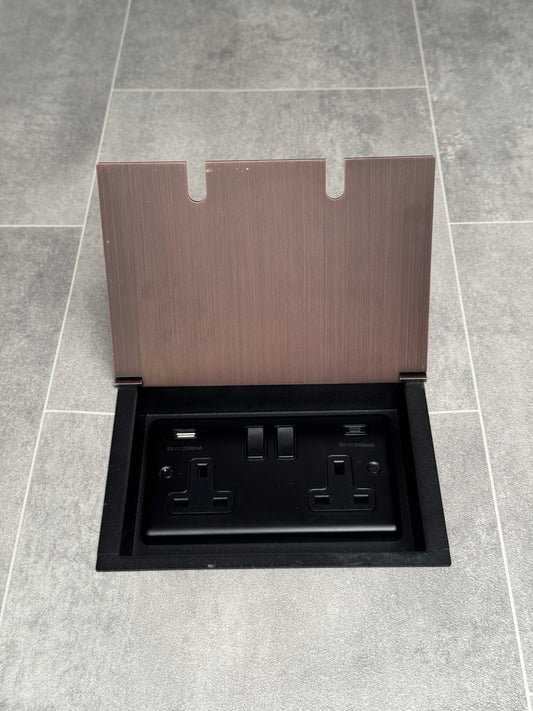 Antique copper recessed floor socket with a double USB A + C plug socket.