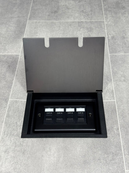 Old bronze double recessed floor socket with a black base installed on a grey floor, opened to show the 4 gang RJ45 cat6 socket.