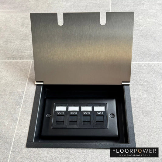 A recessed floor socket in satin nickel with a double box design, including 4 gang RJ45 cat6 sockets, opened and set in a tiled floor.
