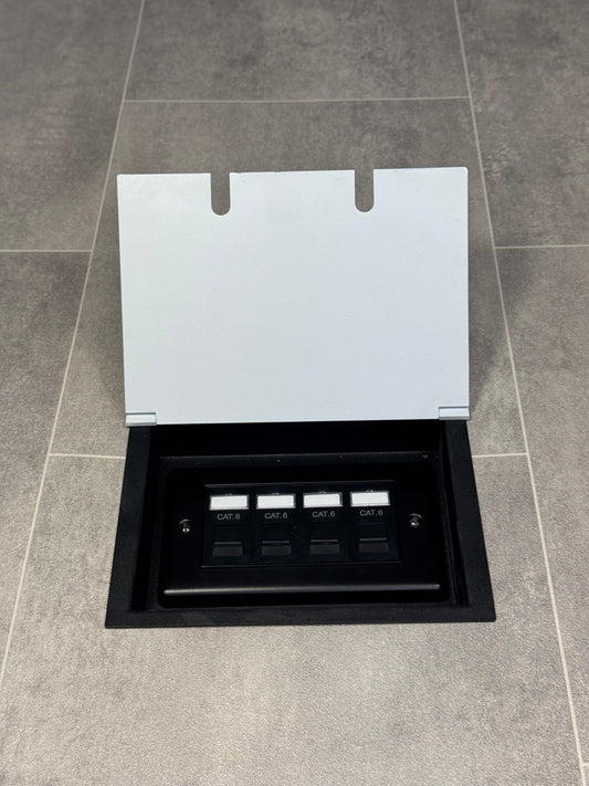 A white double recessed floor socket with a 4 gang RJ45 cat6 socket in a tiled floor.