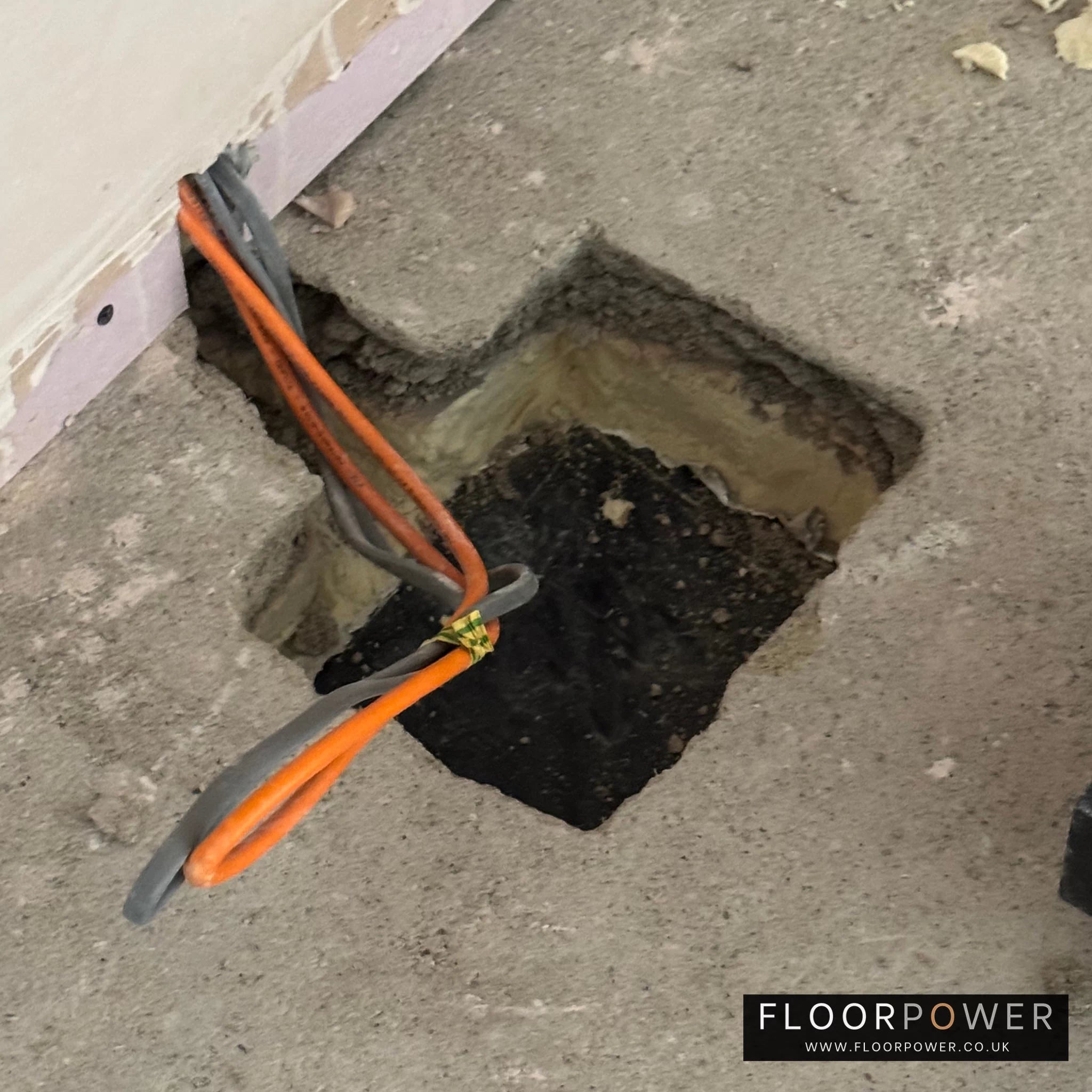 Installing a recessed floor socket, cutting a hole in the concrete floor.