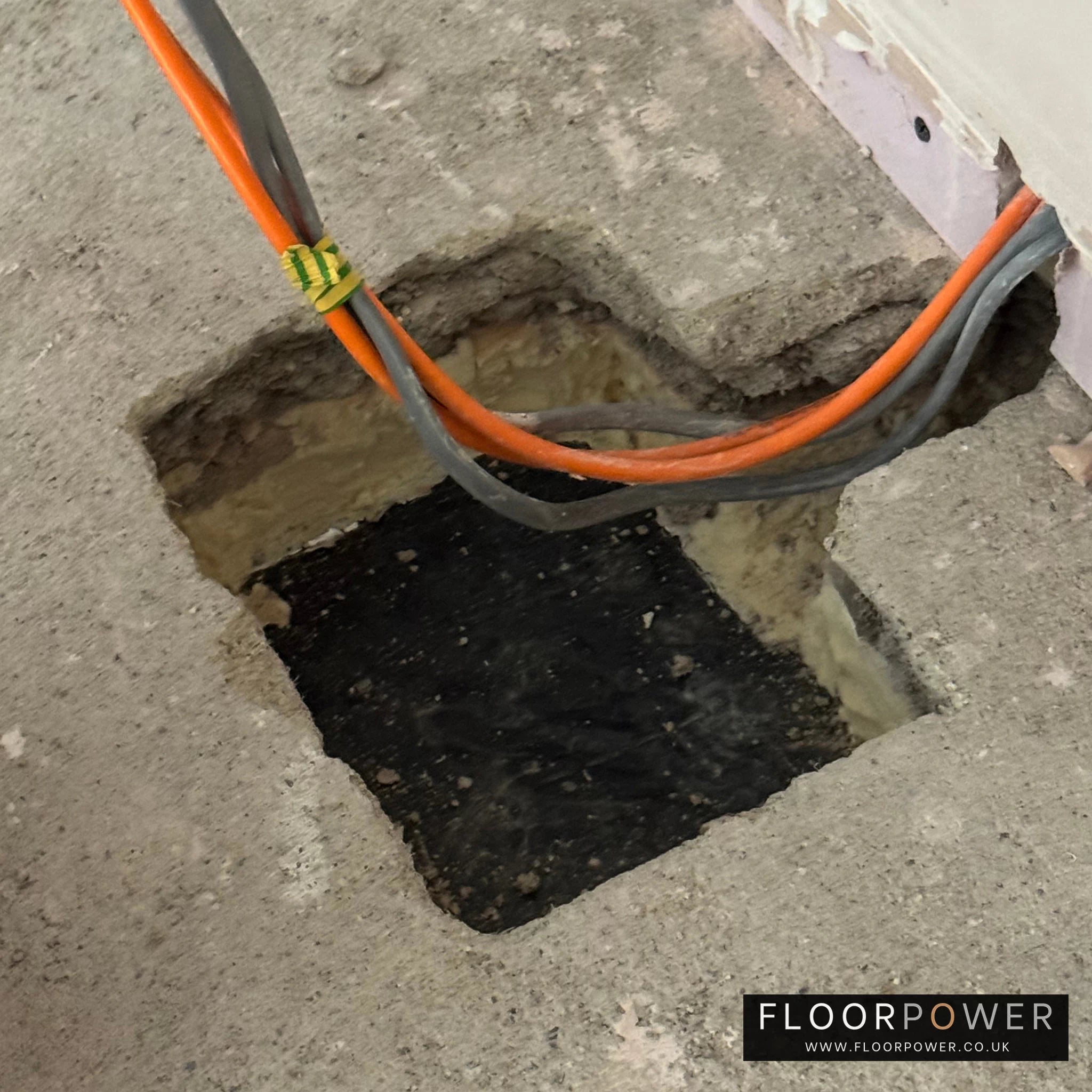Installing a recessed floor socket, cutting a hole in the concrete floor.