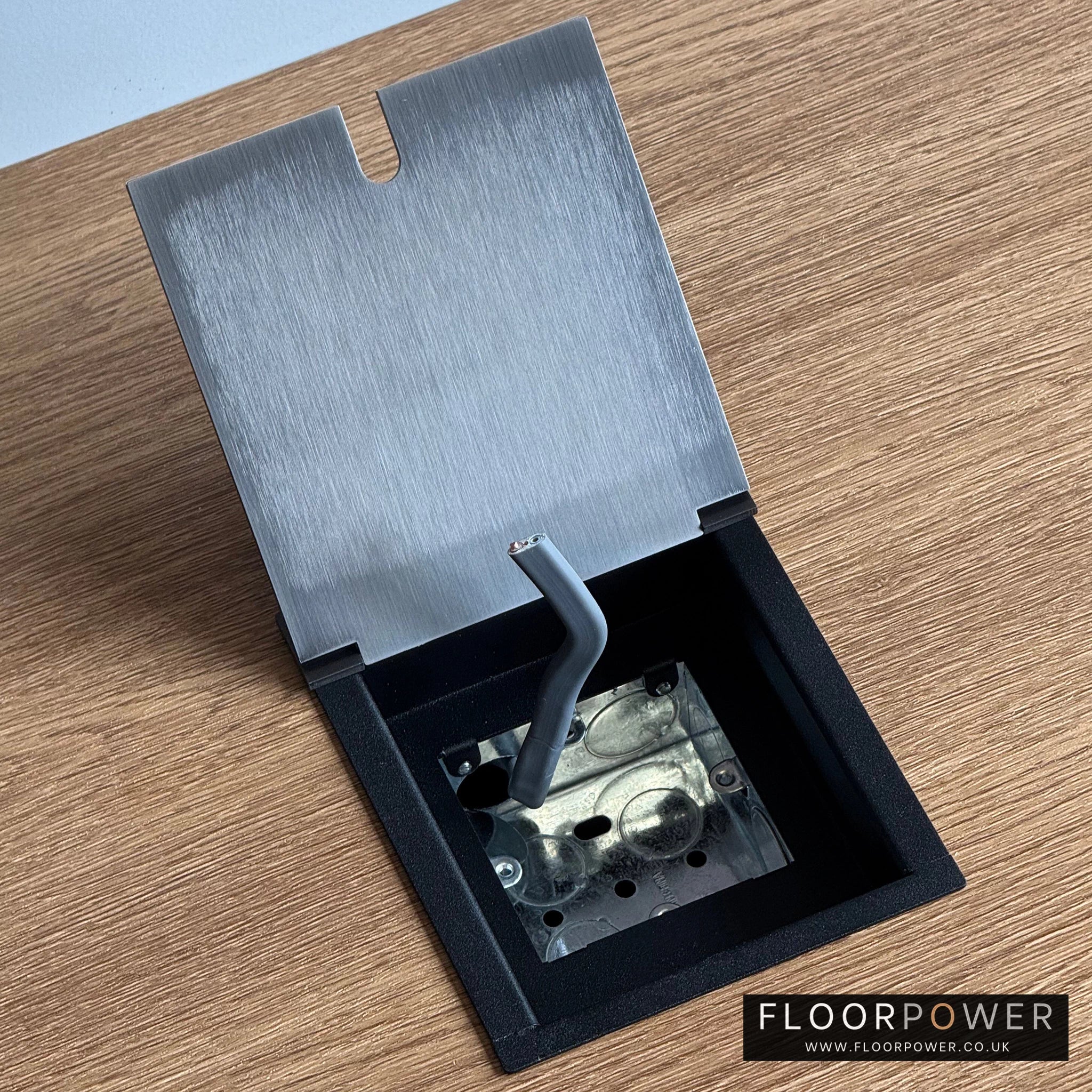 Pulling the cable into the recessed floor socket.