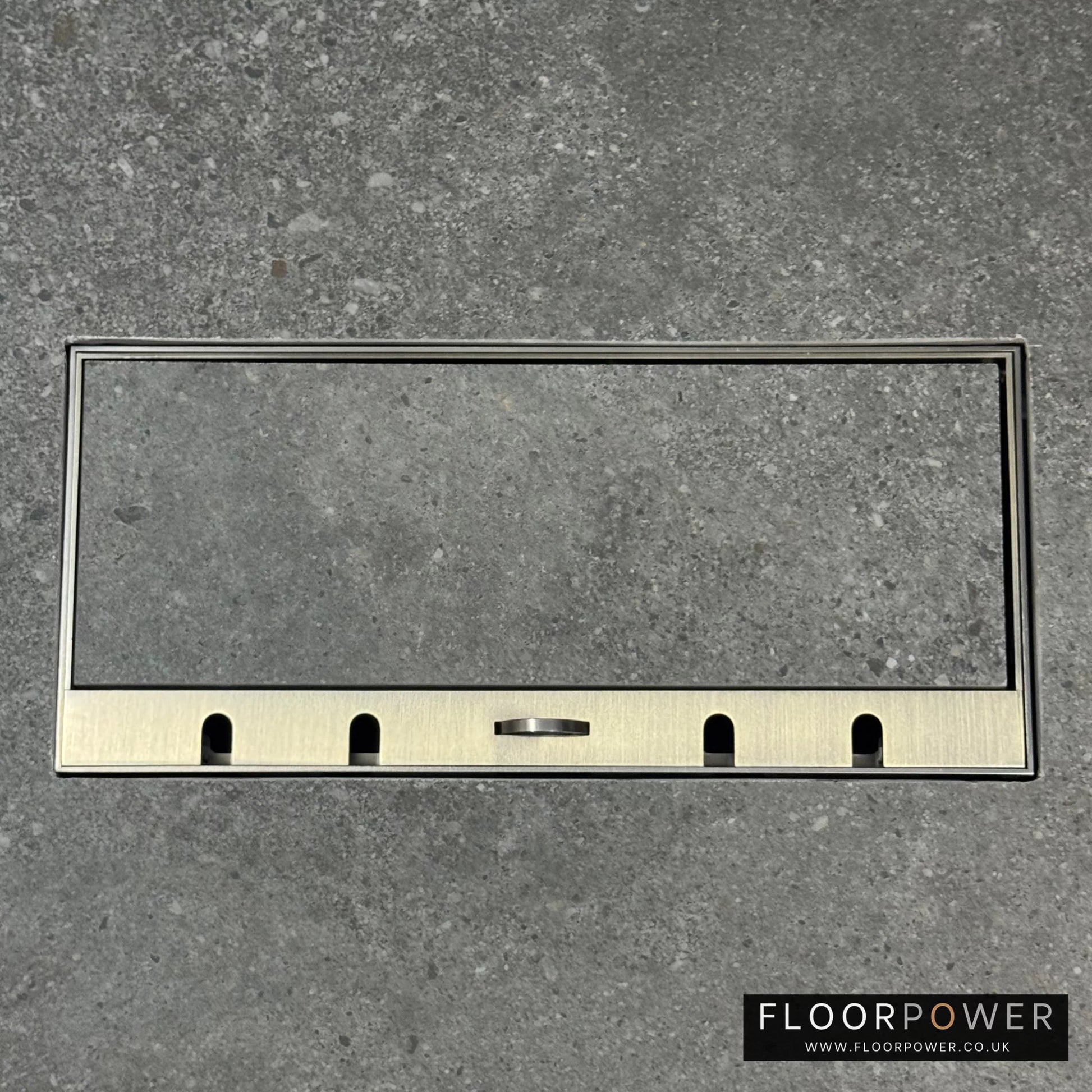 Flush Recessed Floor Socket with Antique Brass Surround in grey stone floor showing the lid handle in the up position