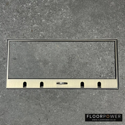 Flush Recessed Floor Socket with Antique Brass Surround in grey stone floor showing the lid handle in the up position