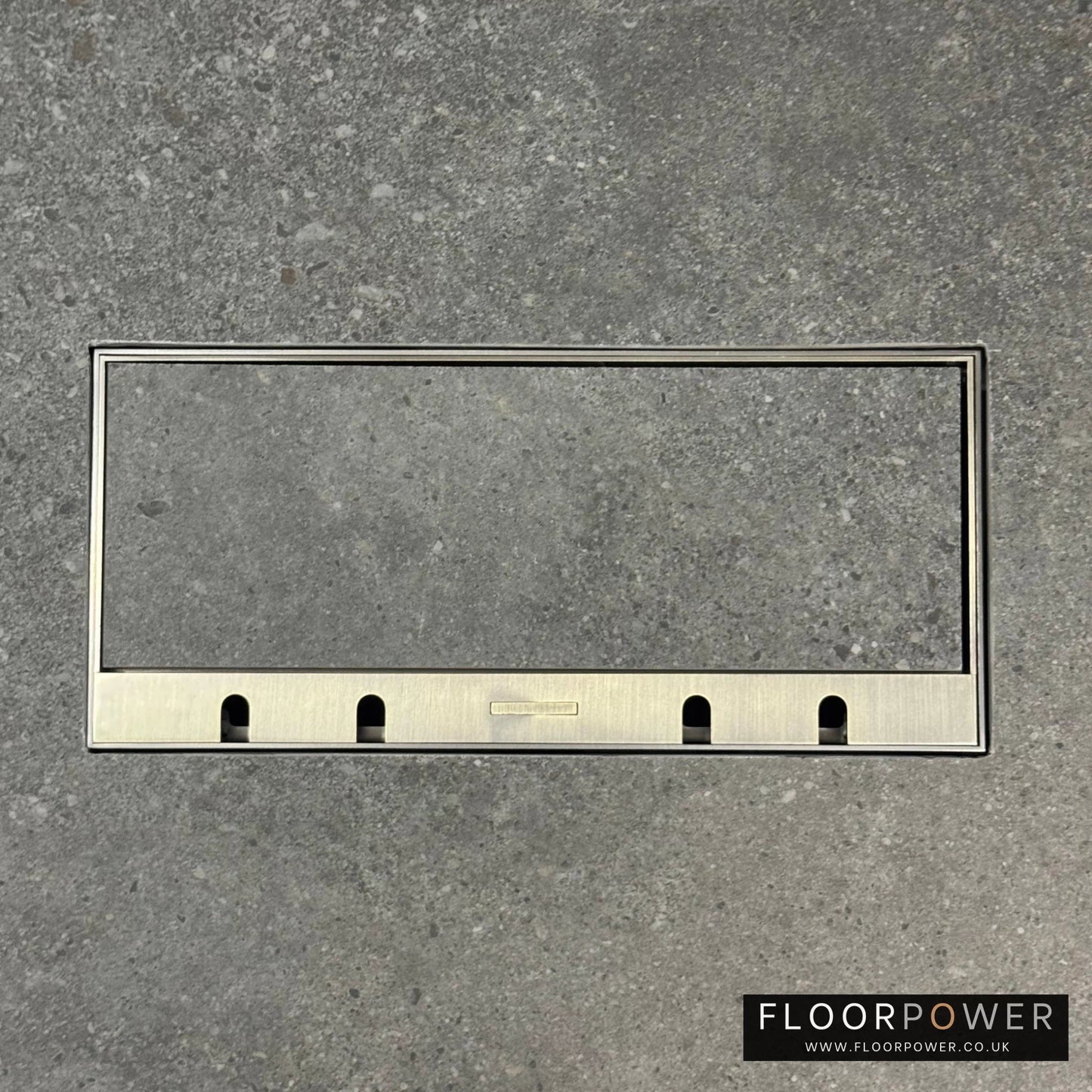 Flush Recessed Floor Socket with Antique Brass Surround in grey stone floor