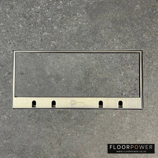Flush Recessed Floor Socket with Antique Brass Surround in grey stone floor