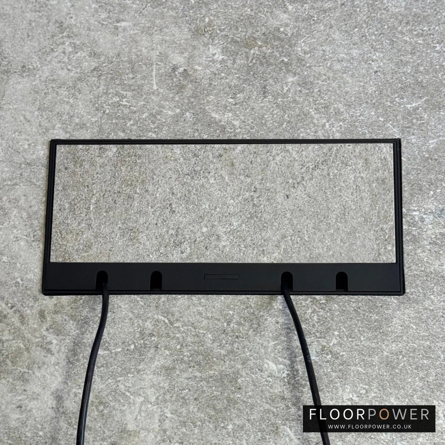 Flush Recessed Floor Socket with Black Surround in light stone floor showing closed lid and 2 wires coming out