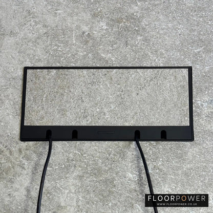 Flush Recessed Floor Socket with Black Surround in light stone floor showing closed lid and 2 wires coming out