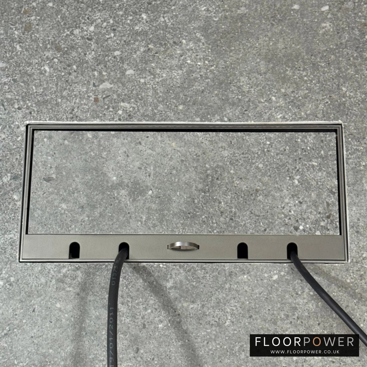 Flush Recessed Floor Socket with Old Bronze Surround in grey stone floor showing closed lid and 2 wires coming out