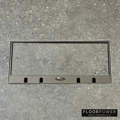 Flush Recessed Floor Socket with Old Bronze Surround in grey stone floor showing the lid handle in the up position