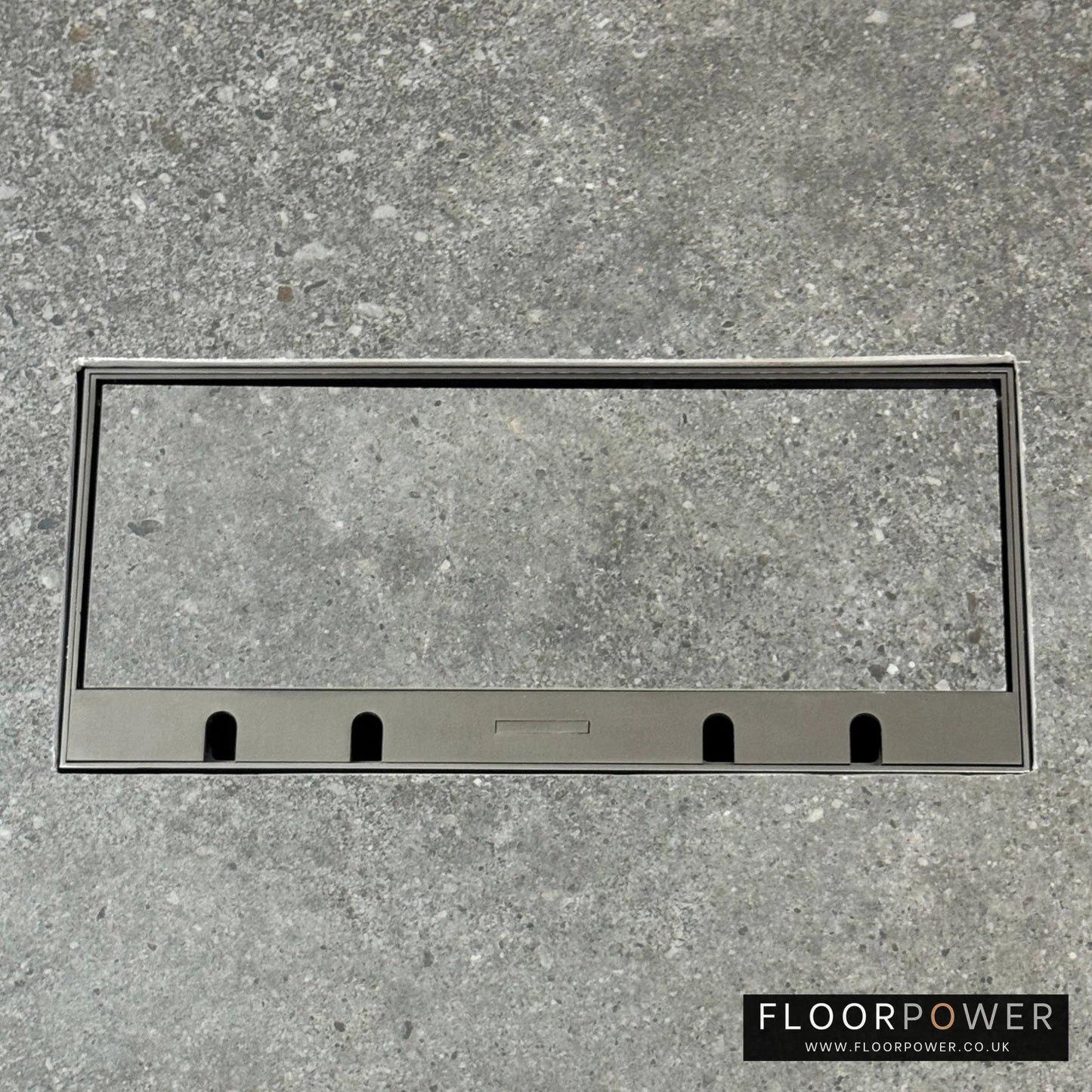 Flush Recessed Floor Socket with Old Bronze Surround in grey stone floor