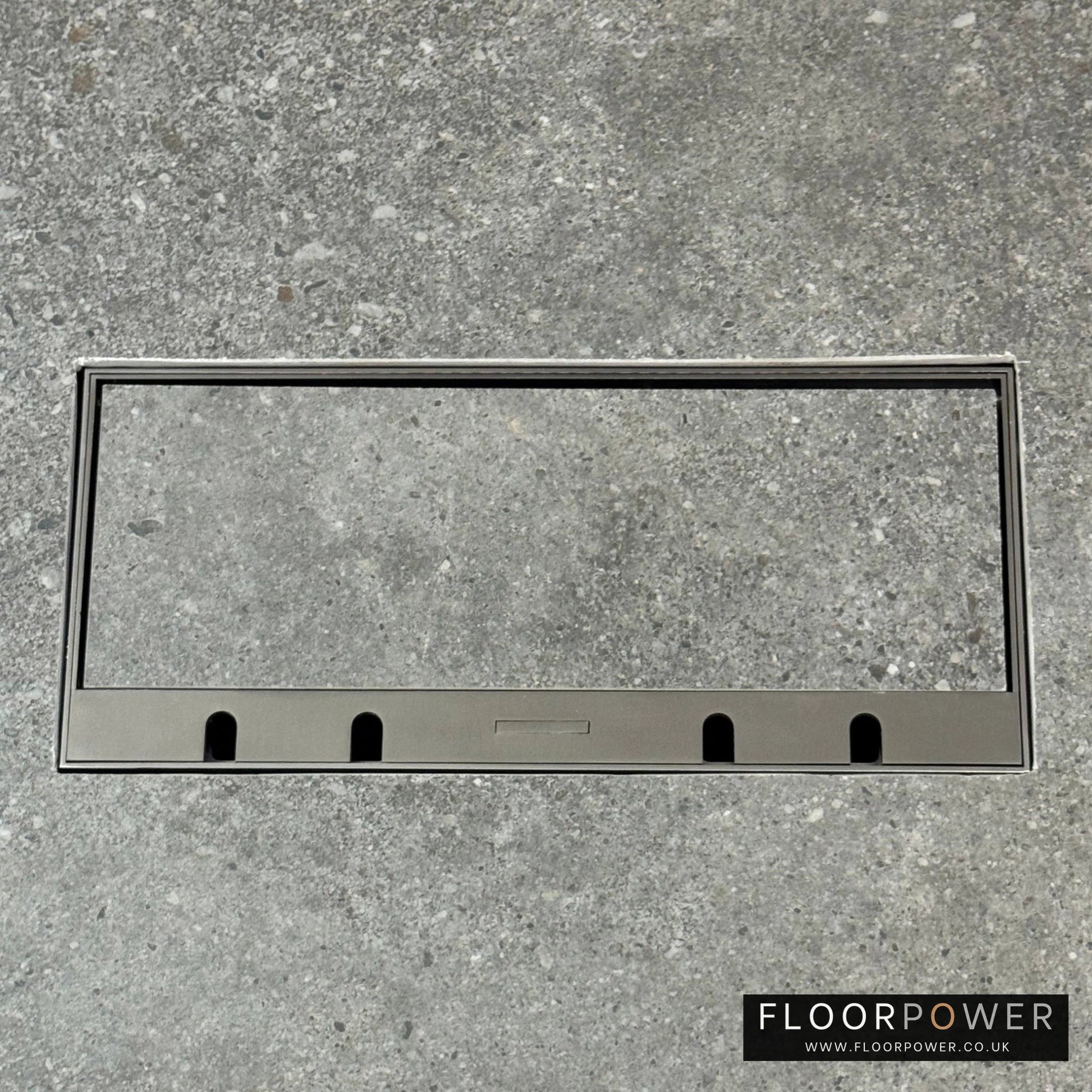 Flush Recessed Floor Socket with Old Bronze Surround in grey stone floor