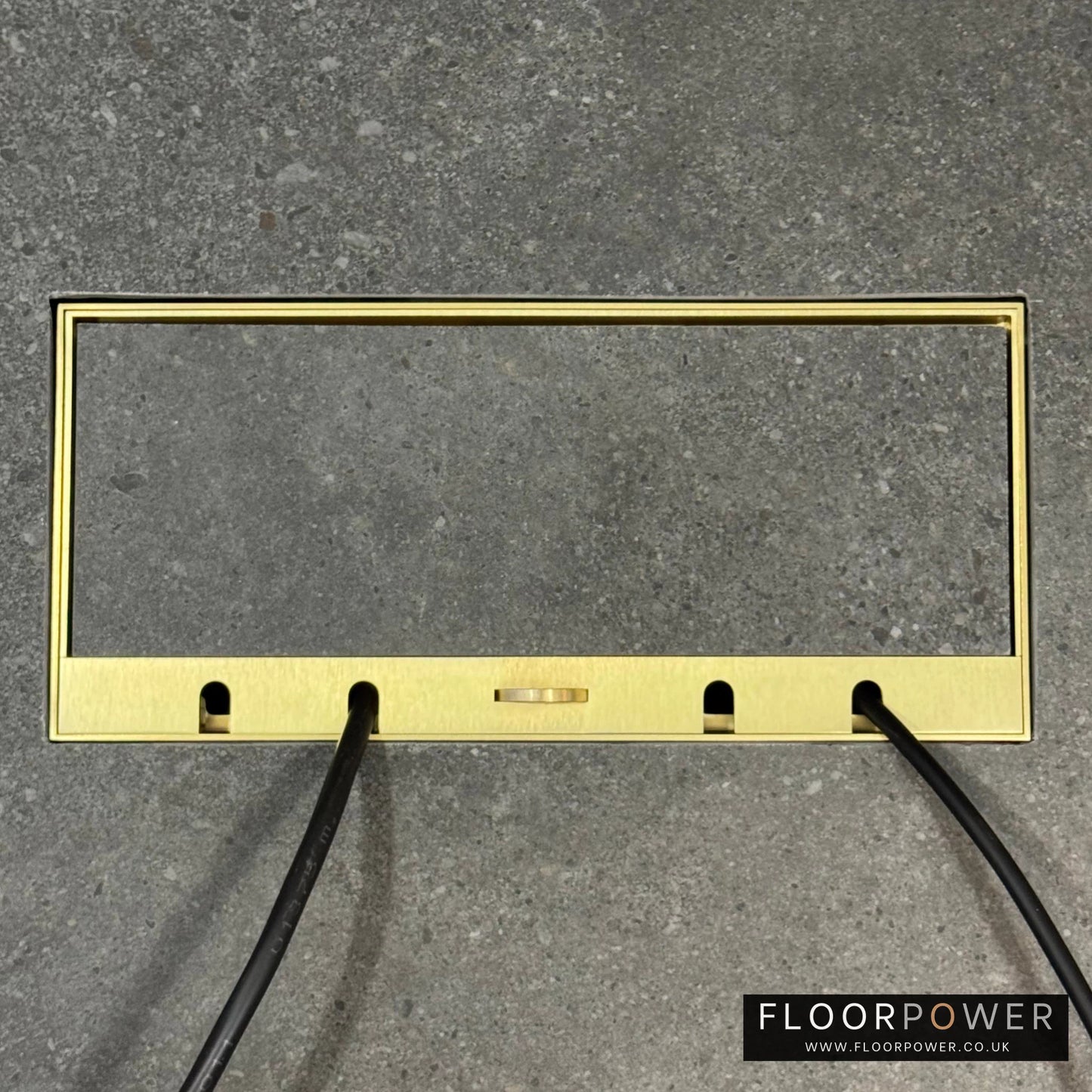 Flush Recessed Floor Socket with Satin Brass Surround in grey stone floor showing closed lid and 2 wires coming out