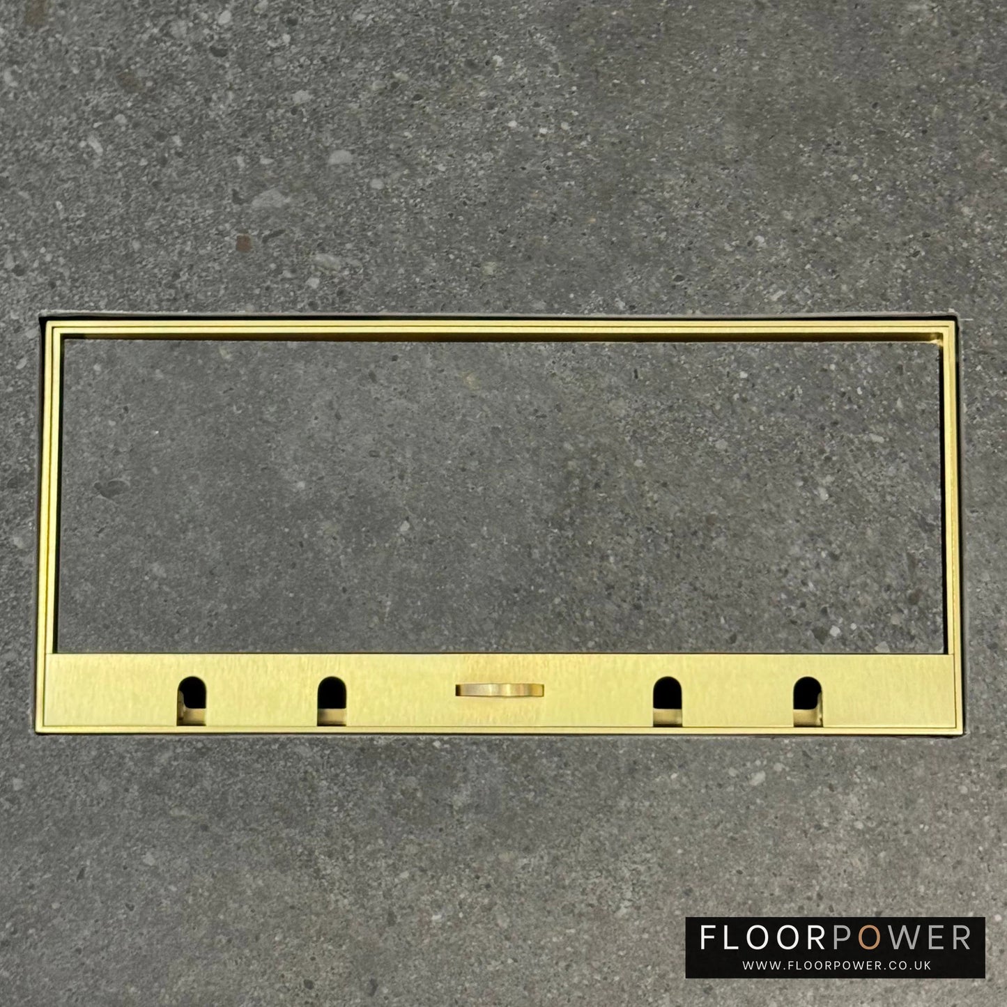 Flush Recessed Floor Socket with Satin Brass Surround in grey stone floor showing the lid handle in the up position