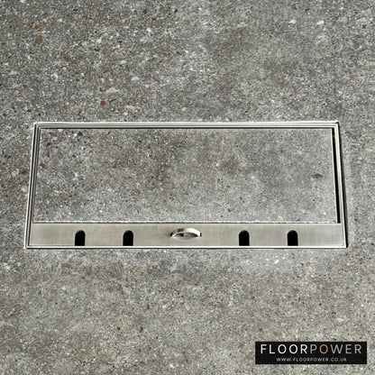 Flush Recessed Floor Socket with Satin Stainless Surround in grey stone floor showing the lid handle in the up position