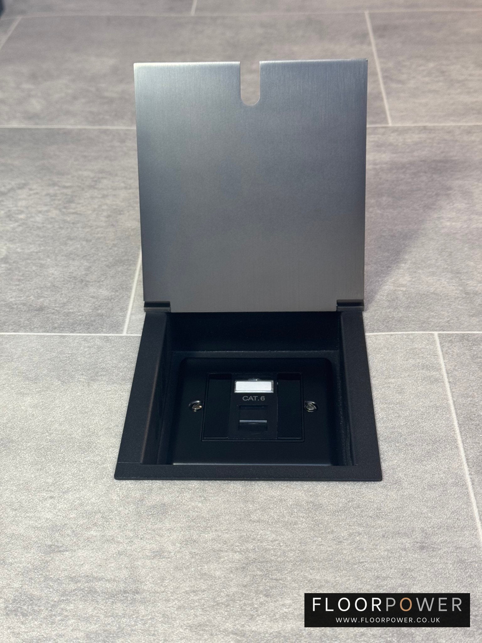 Old bronze recessed floor socket with a black base, opened to reveal the internal Cat6 RJ45 socket.