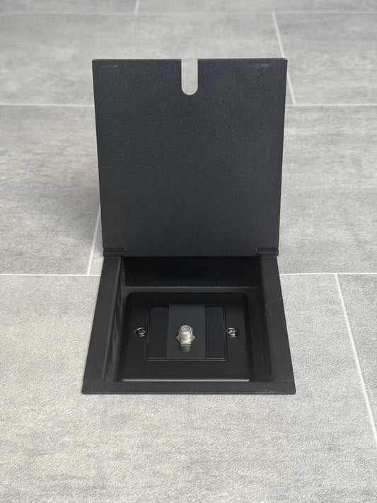 A matt black recessed floor socket with a single gang satellite socket.