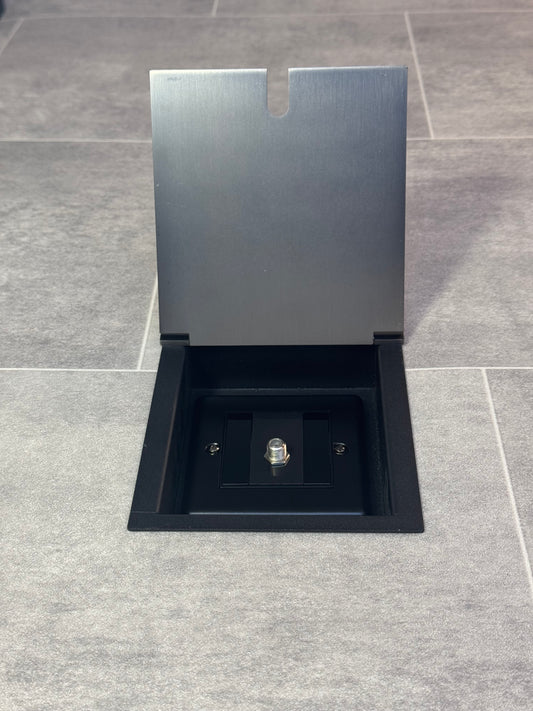  Old bronze recessed floor socket with the cover open showing the single satellite connector inside.