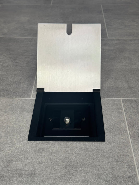 A satin stainless steel recessed floor socket with a single satellite socket, displayed in an open position on a grey tiled floor.