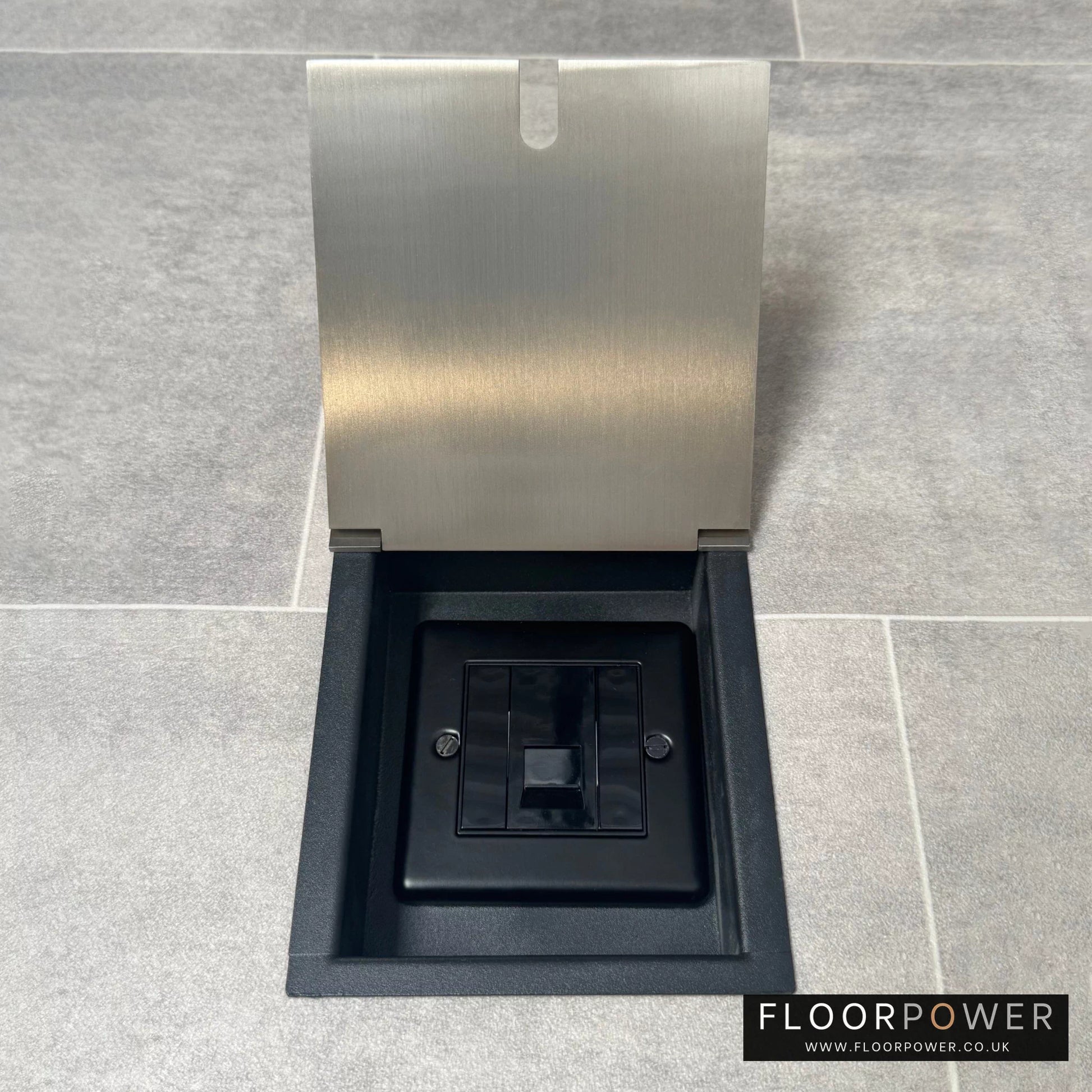 Satin nickel recessed floor socket with lid open to show the single phone socket.