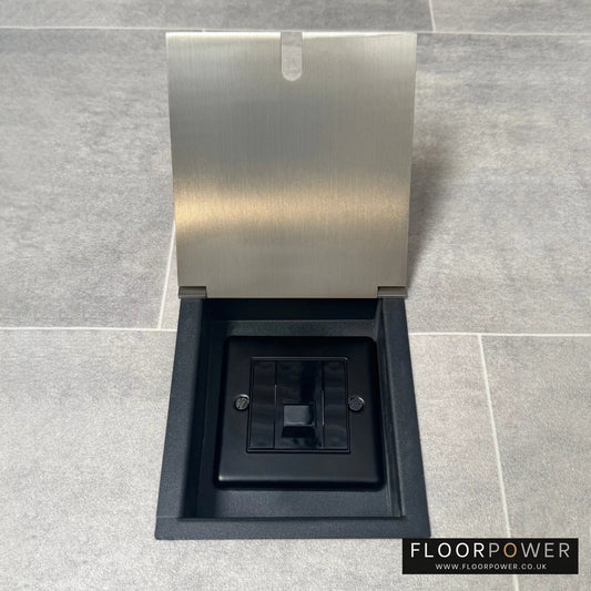 Satin nickel recessed floor socket with lid open to show the single phone socket.