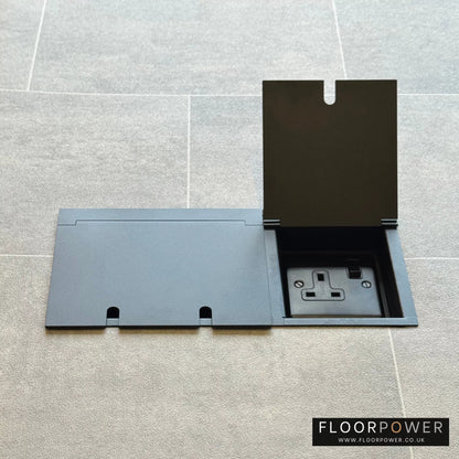 Matt Black triple floor plug socket with double 13A switched plug socket and a single 13A switched plug socket, both lids open.