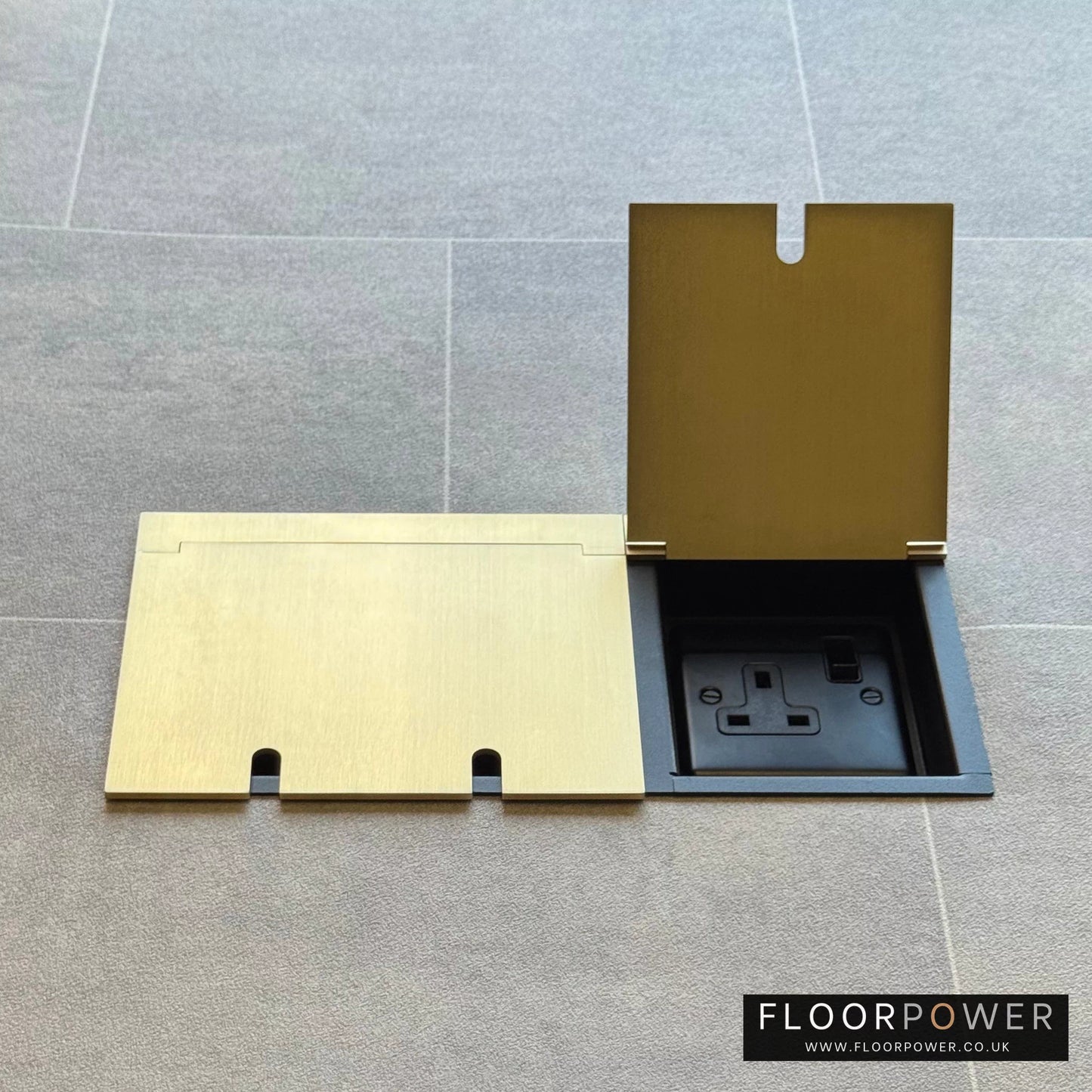Triple plug floor socket in Satin Brass with single 13A switched plug socket lid open.