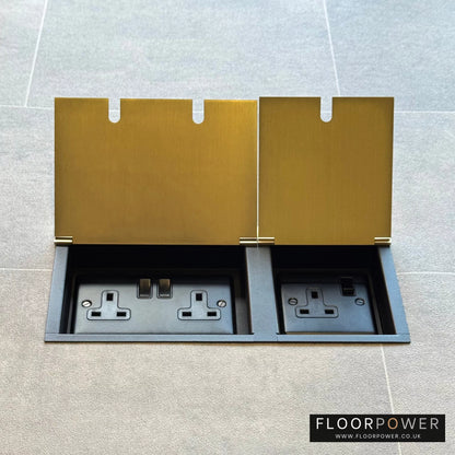 Satin Brass triple floor plug socket with double 13A switched plug socket and a single 13A switched plug socket, both lids open.