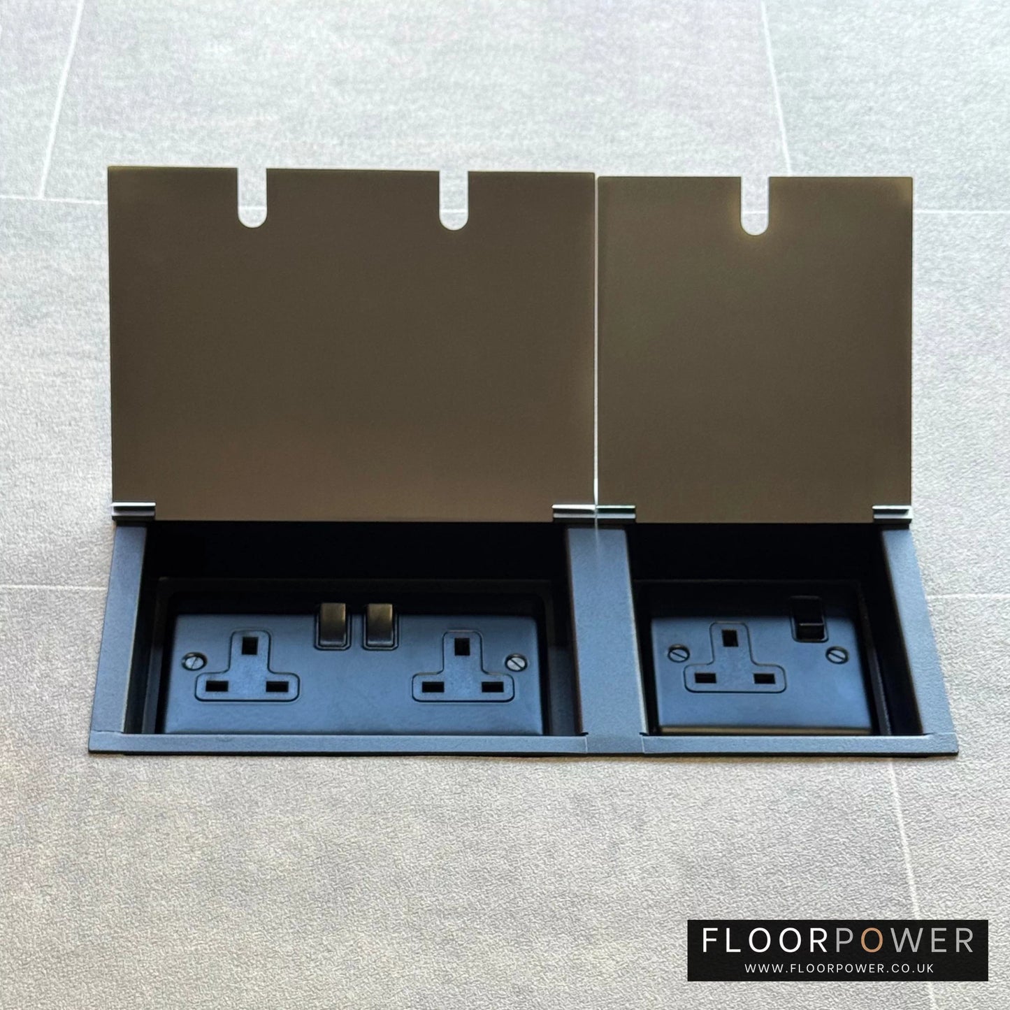 Satin Nickel triple floor plug socket with double 13A switched plug socket and a single 13A switched plug socket, both lids open.