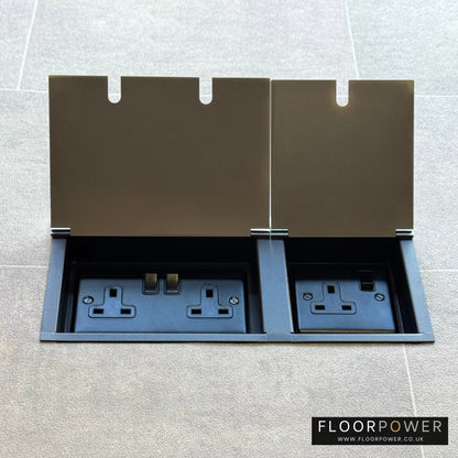 Satin Nickel triple floor plug socket with double 13A switched plug socket and a single 13A switched plug socket, both lids open.