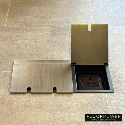 Lighting combination triple floor socket in Antique Brass with 5A round pin socket lid open.