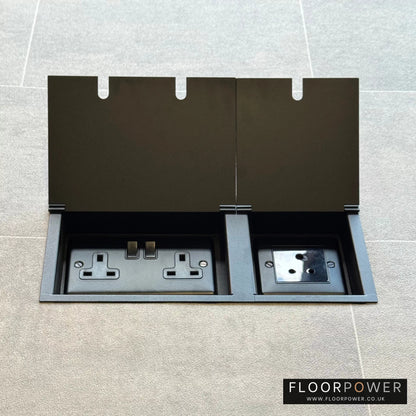 Matt Black lighting combination triple floor socket with double 13A switched plug socket and a 5A round pin socket, both lids open.