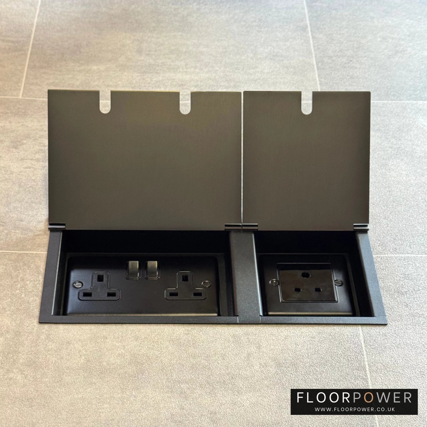 Old Bronze lighting combination triple floor socket with double 13A switched plug socket and a 5A round pin socket, both lids open.