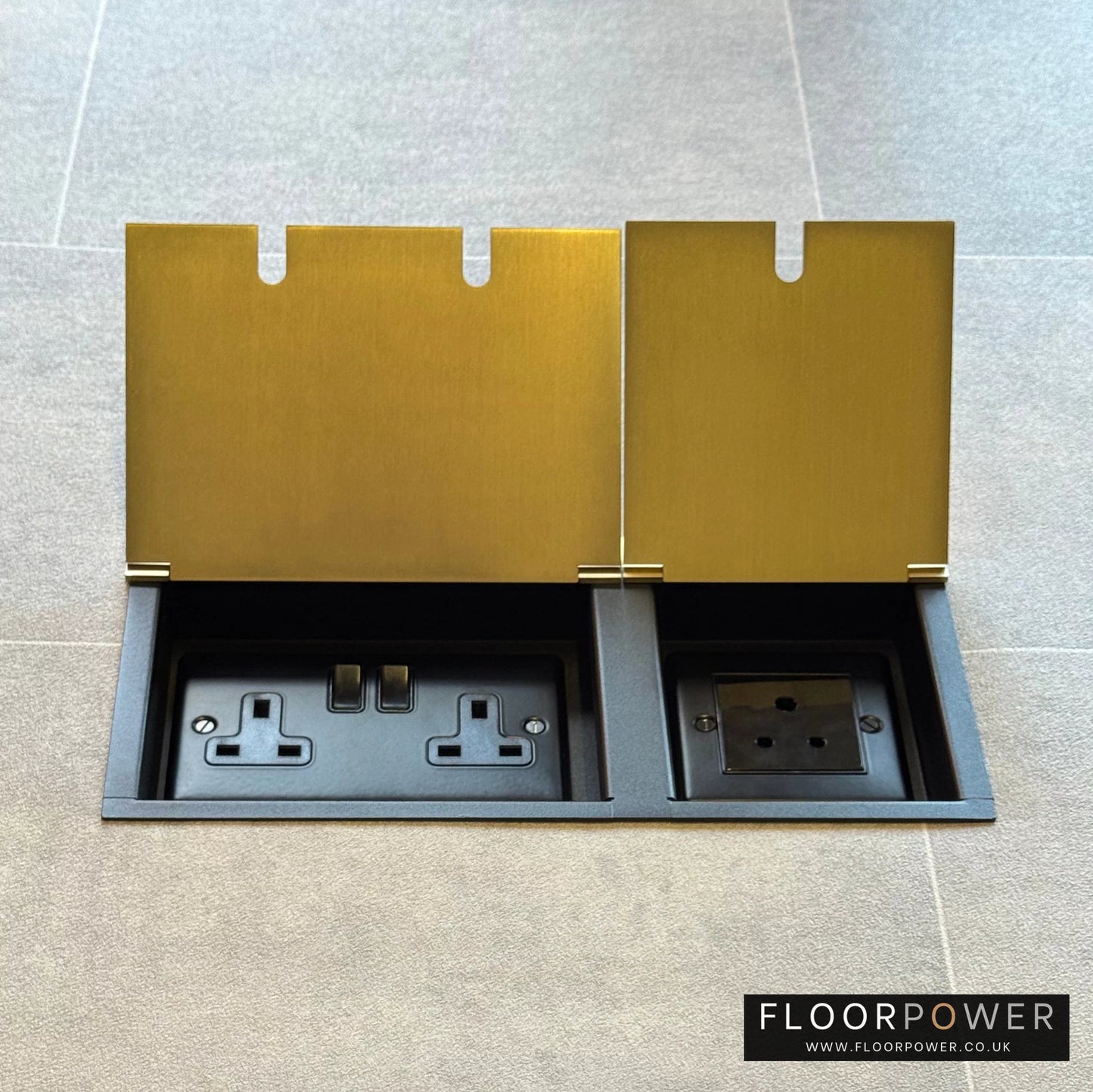 Satin Brass lighting combination triple floor socket with double 13A switched plug socket and a 5A round pin socket, both lids open.