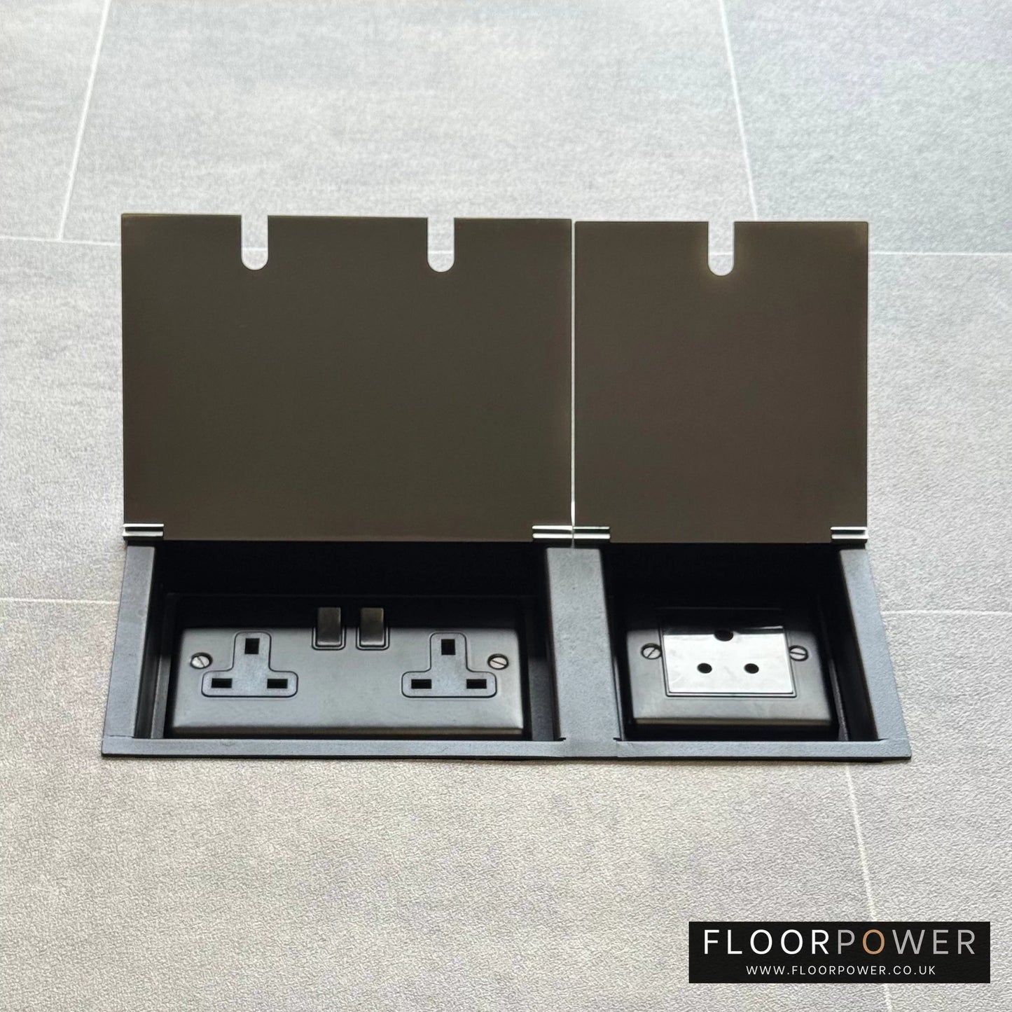 Satin Stainless lighting combination triple floor socket with double 13A switched plug socket and a 5A round pin socket, both lids open.