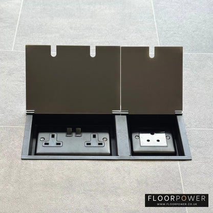 Satin Stainless lighting combination triple floor socket with double 13A switched plug socket and a 5A round pin socket, both lids open.