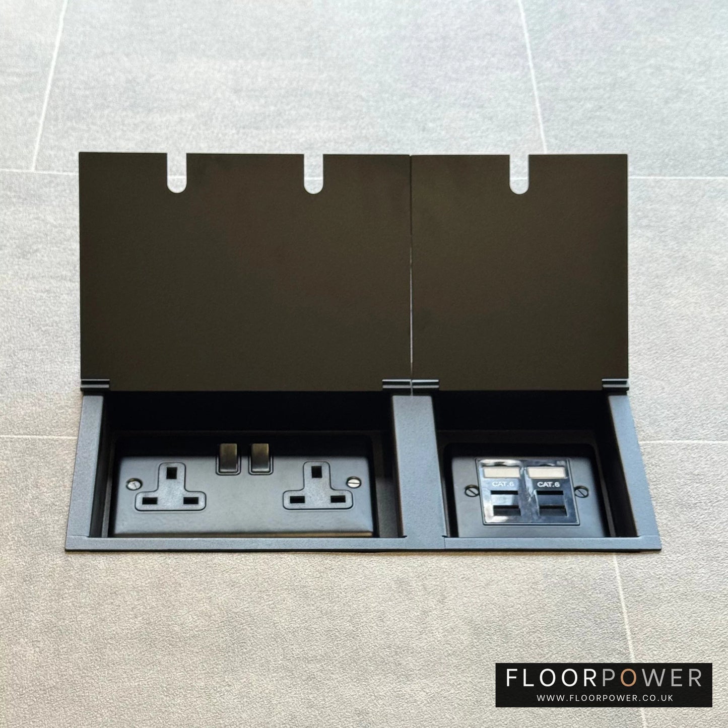 Matt Black network combination triple floor socket with double 13A switched plug socket and two RJ45 Cat6 network socket, both lids open.