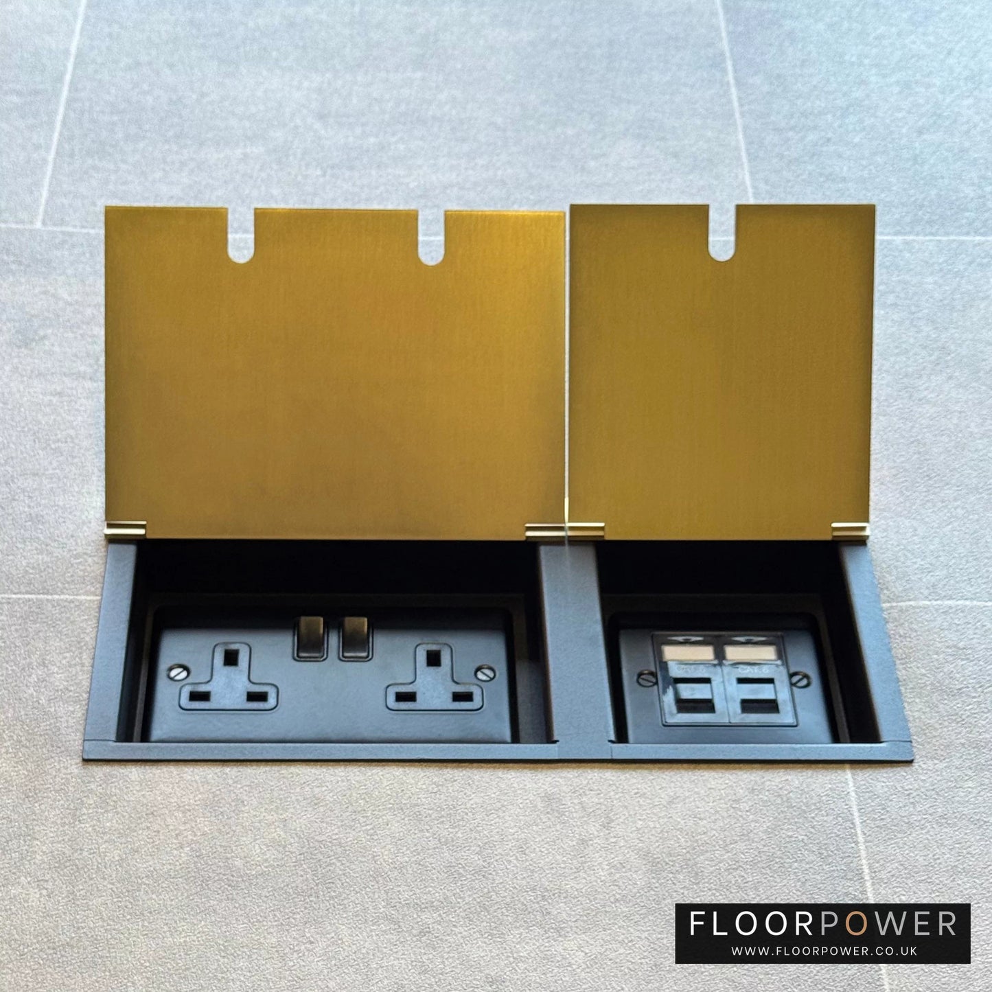 Satin Brass network combination triple floor socket with double 13A switched plug socket and two RJ45 Cat6 network socket, both lids open.